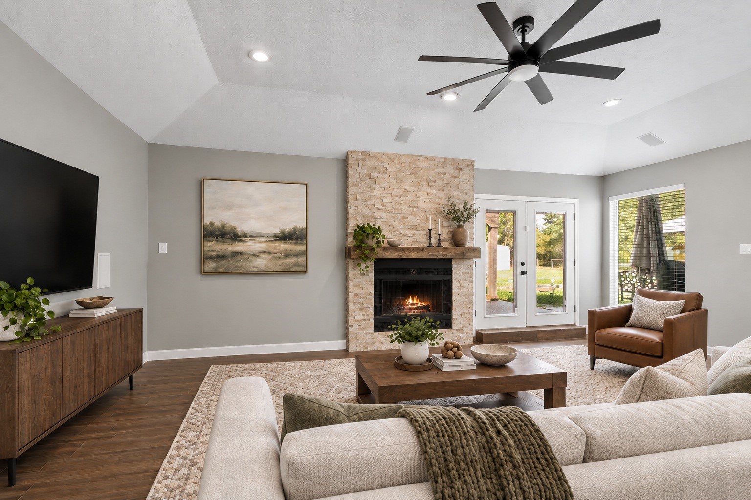 3527 Eula Morgan Road Katy, TX 77493 - Photo 5 of 23 The living area is anchored by a stunning stone fireplace with a wood mantel, framed by vaulted ceilings and French doors that bring in plenty of natural light. Virtually staged.