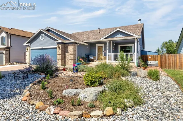 a view of a house with a small yard and plants