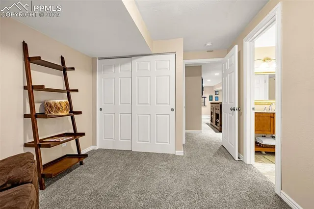 a view of a hallway with wooden floor and workspace
