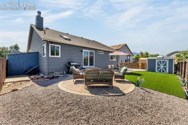 a backyard of a house with yard and outdoor seating