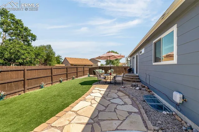 a view of a backyard with sitting area
