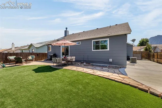 a view of a house with swimming pool and sitting area