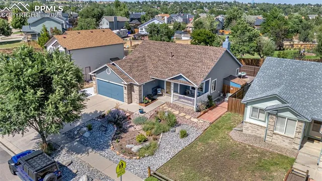 an aerial view of a house with a yard