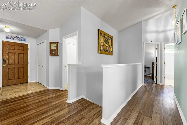 a view of a hallway view with wooden floor and staircase