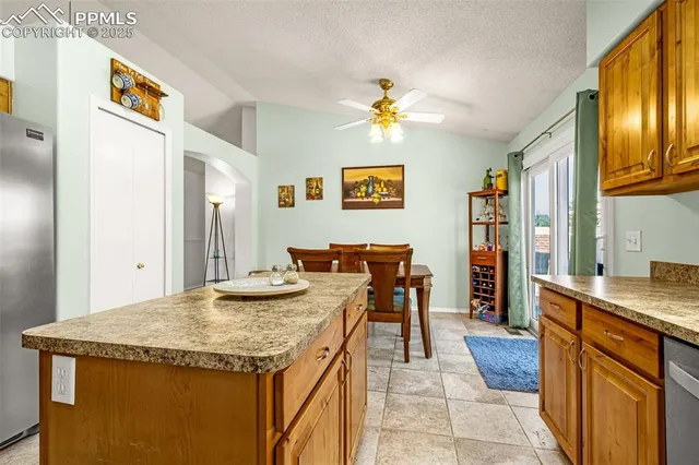 a view of a kitchen area with furniture and wooden floor