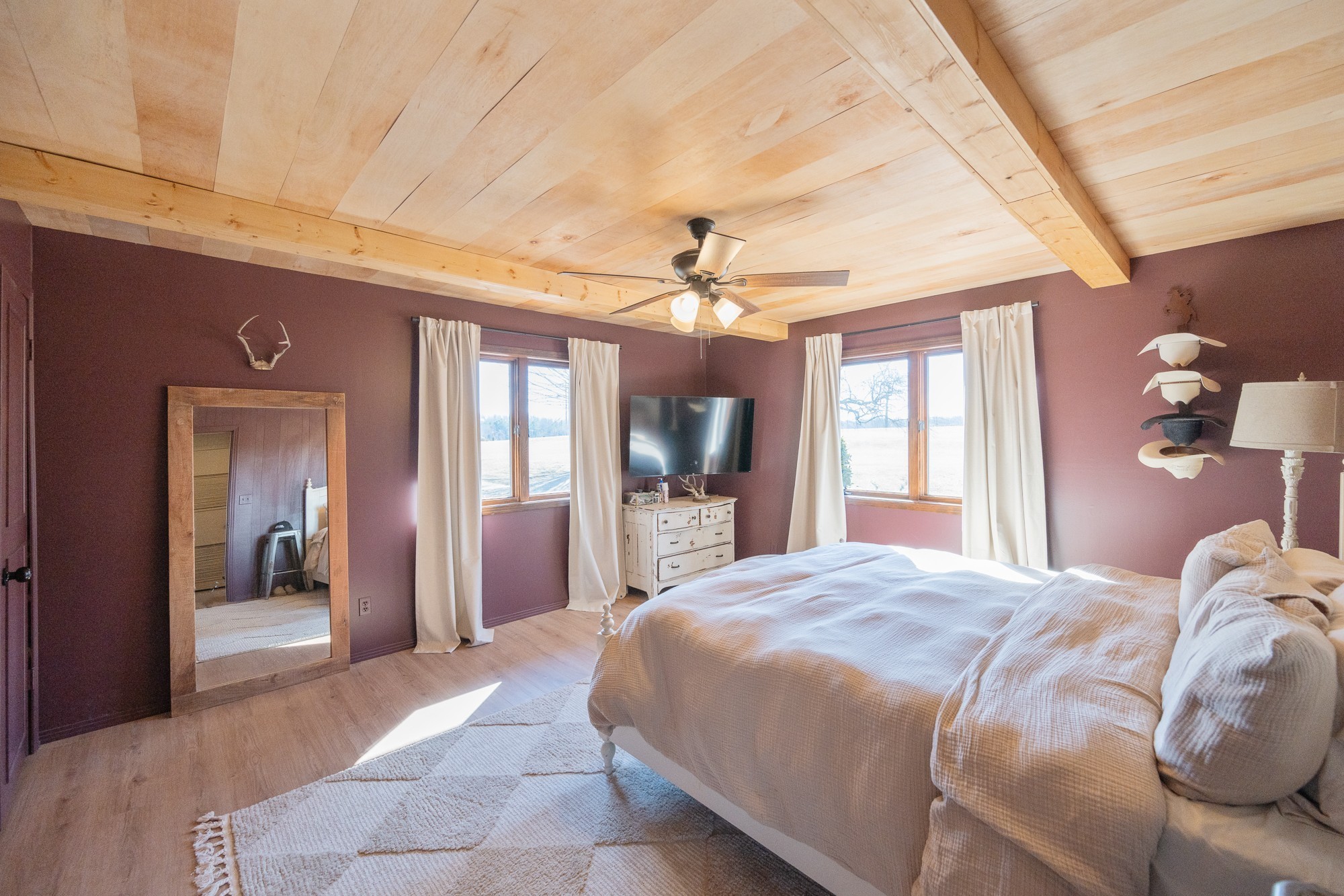 3080 Bible Hill Road Parsons, TN 38363 - Photo 27 of 76 a spacious bedroom with a large bed and a chandelier