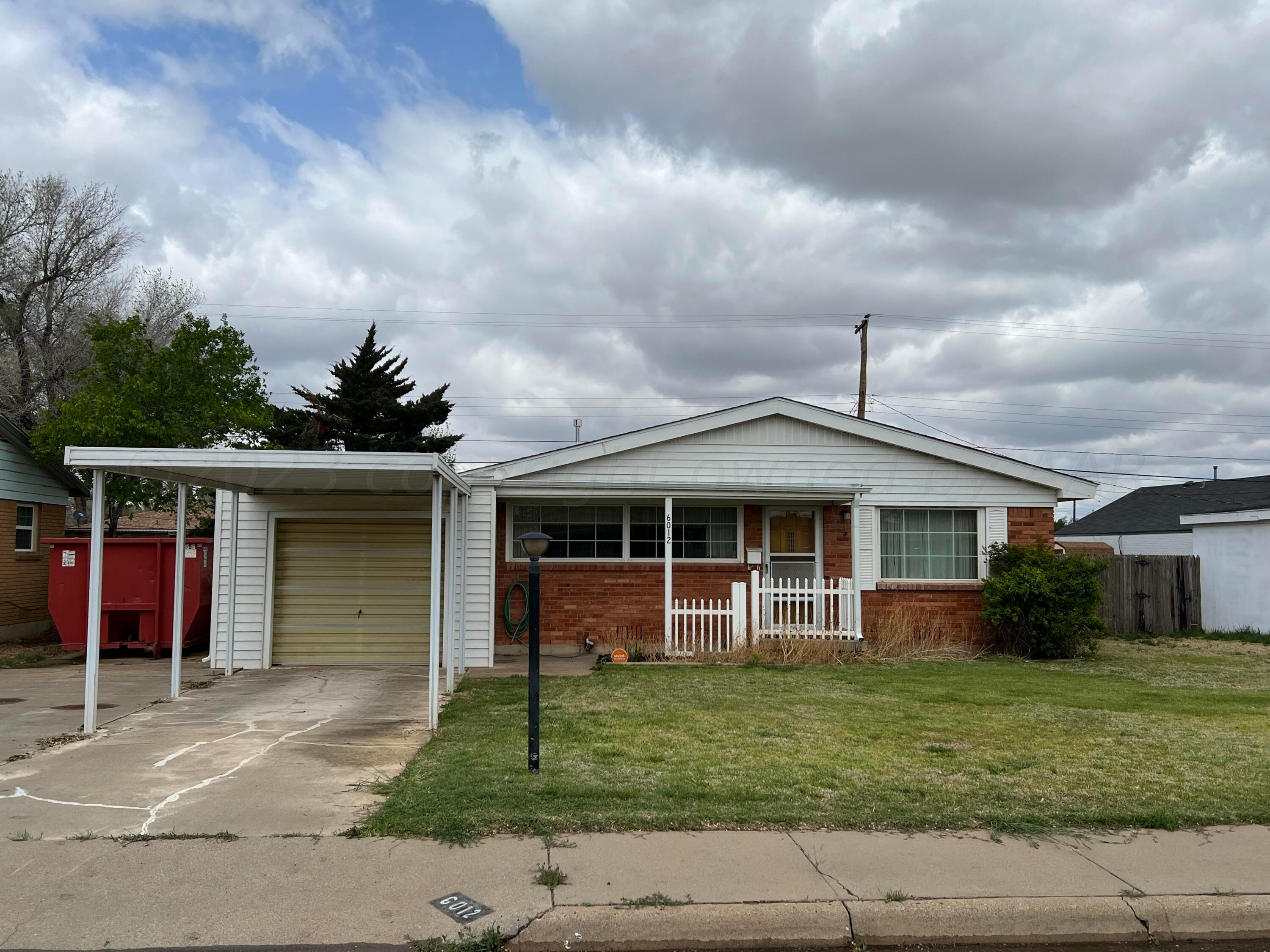 6012 Garden Lane Amarillo, TX 79106 - Photo 1 of 14 a front view of a house with a garden and trees