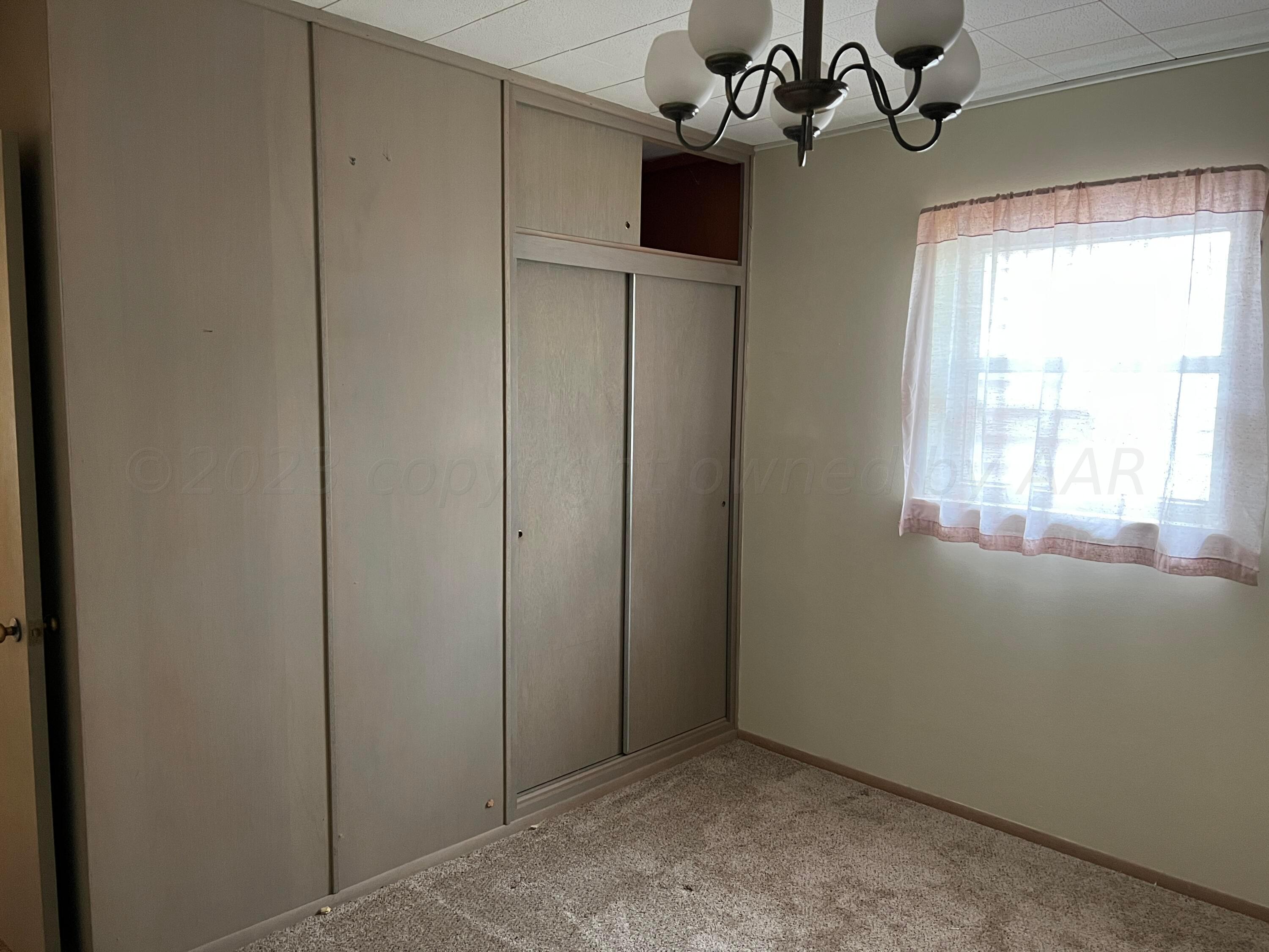 6012 Garden Lane Amarillo, TX 79106 - Photo 11 of 14 a view of a livingroom with a chandelier fan and windows