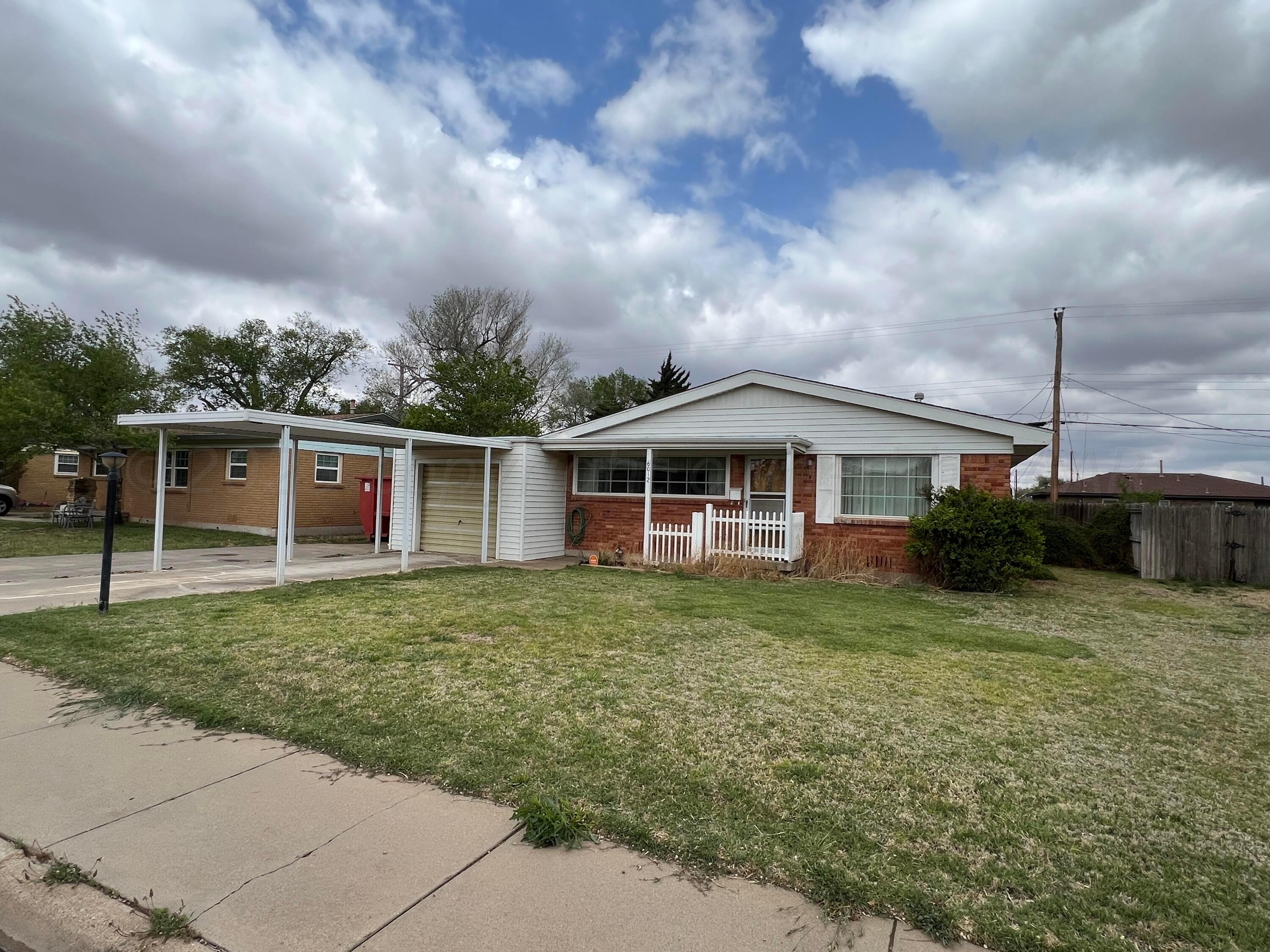 6012 Garden Lane Amarillo, TX 79106 - Photo 2 of 14 a front view of a house with garden