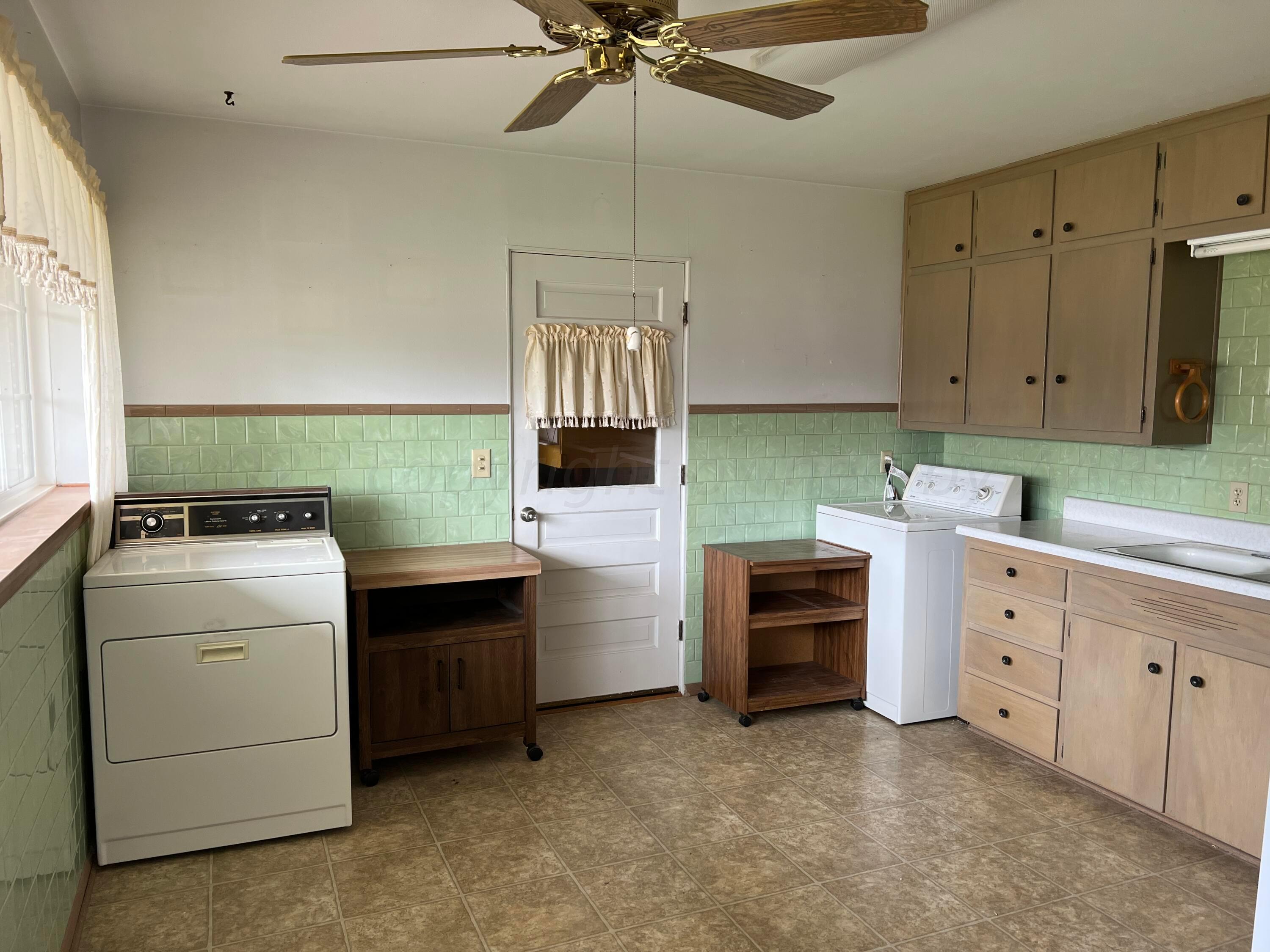 6012 Garden Lane Amarillo, TX 79106 - Photo 3 of 14 a utility room with cabinets washer and dryer