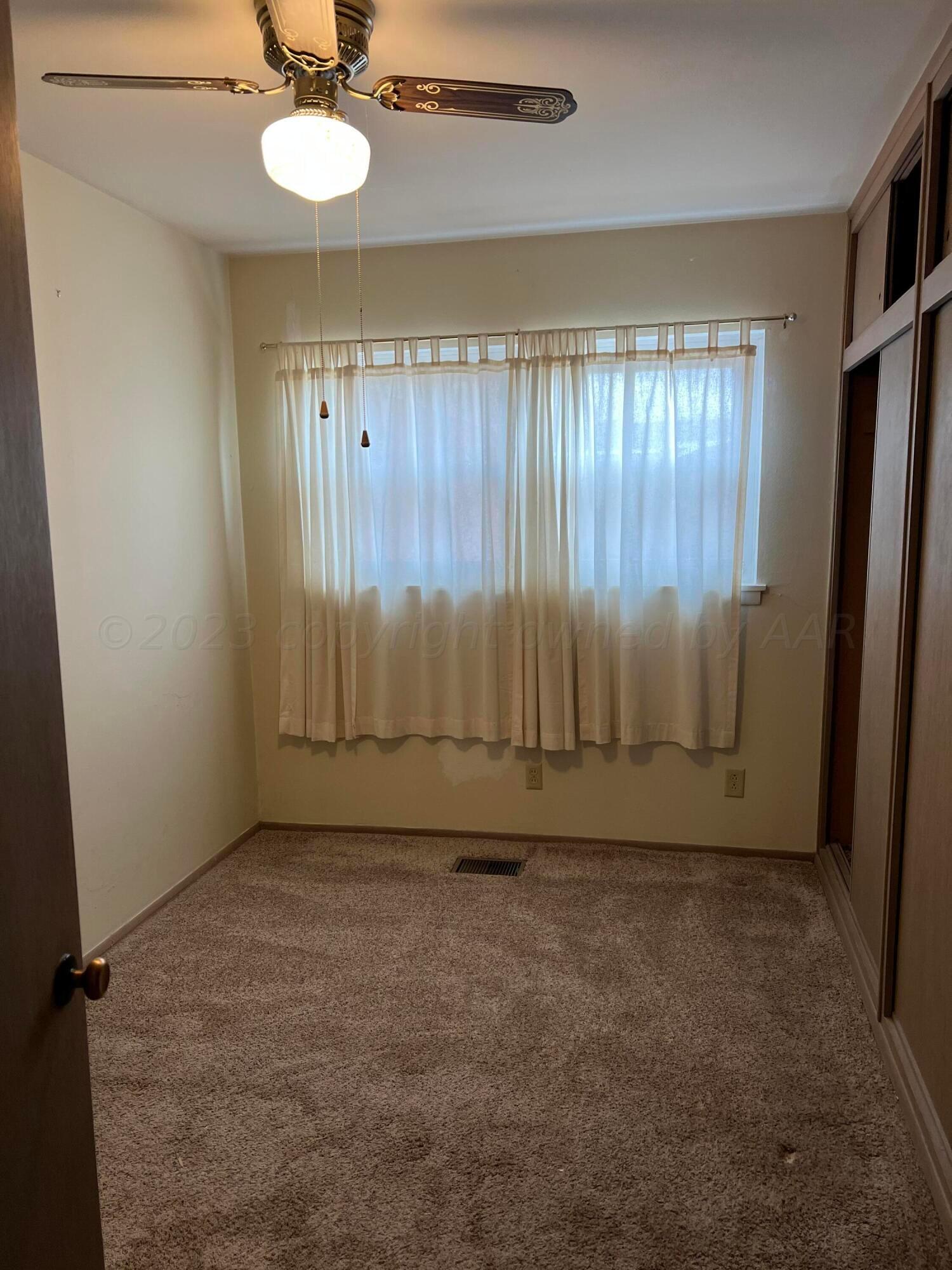 6012 Garden Lane Amarillo, TX 79106 - Photo 8 of 14 an empty room with a window