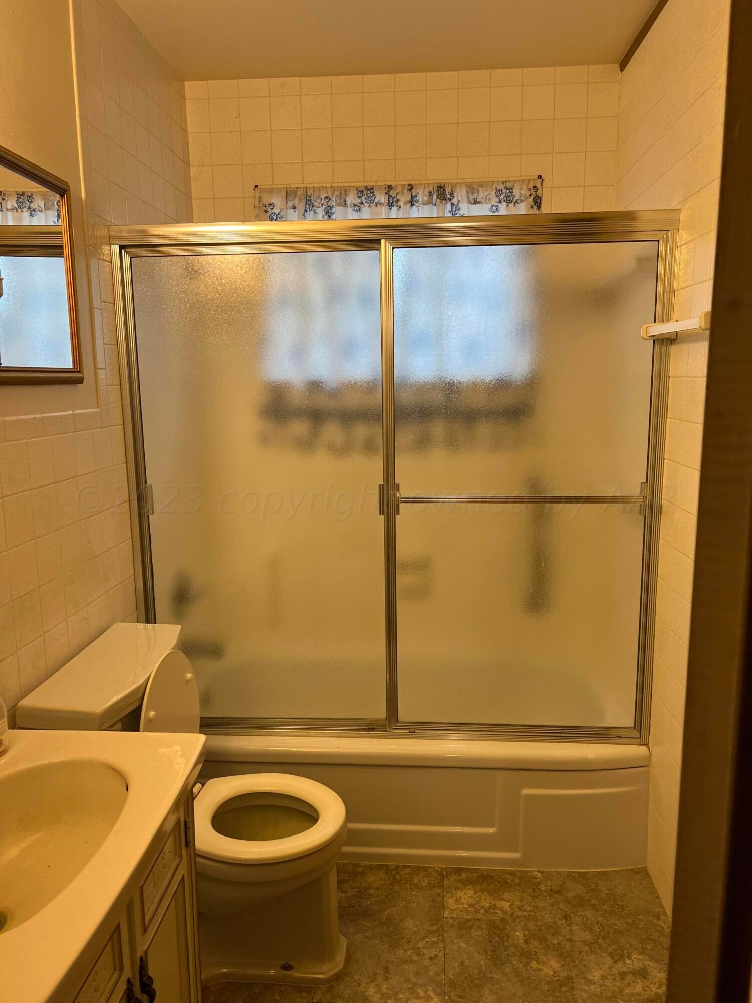 6012 Garden Lane Amarillo, TX 79106 - Photo 9 of 14 a bathroom with a sink and a shower