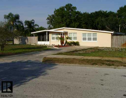 8075 Robin Road Largo, FL 33777 - Photo 1 of 1 a front view of a house with a garden