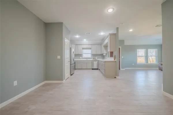a view of a kitchen with a sink and cabinets
