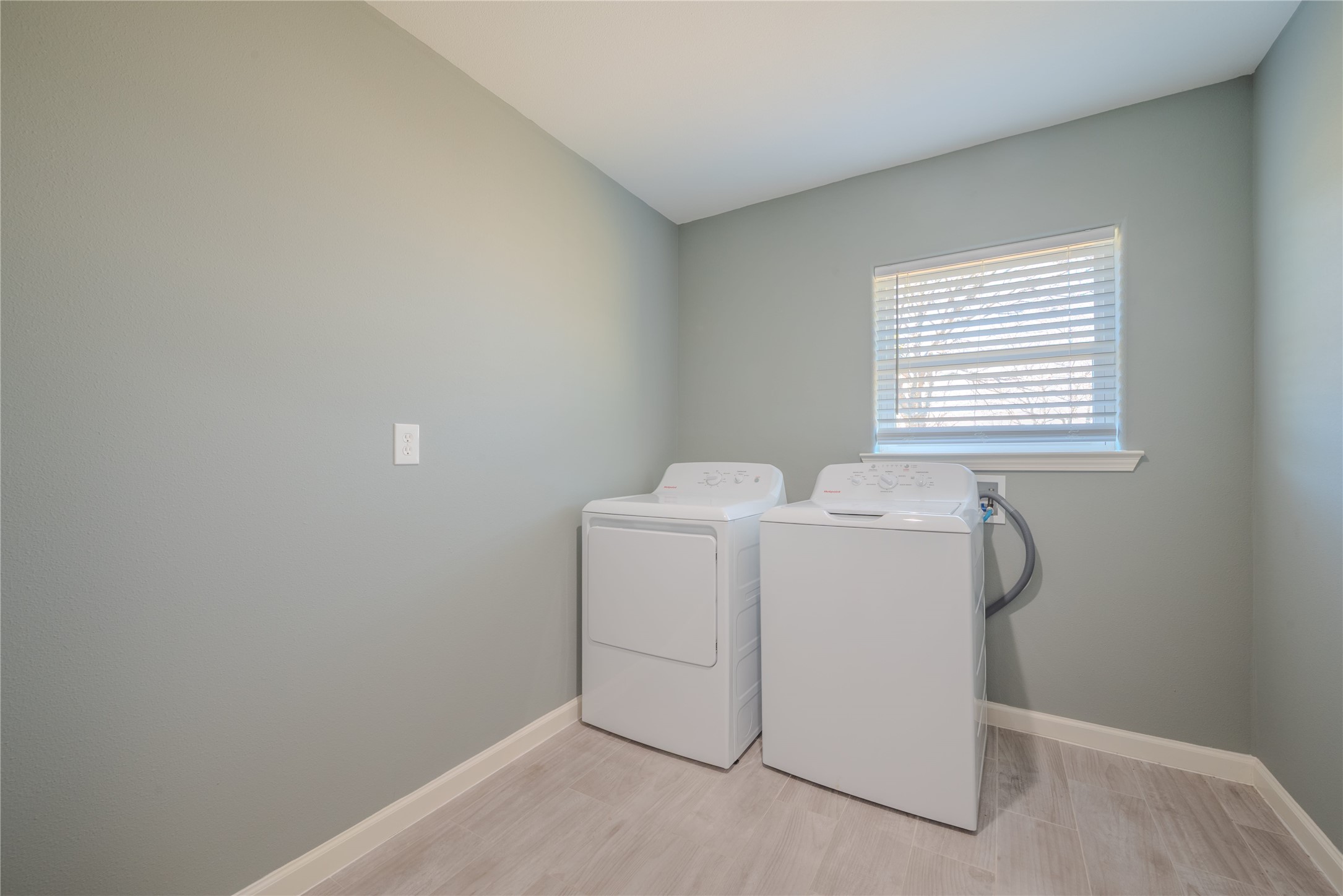 4340 Highway 60 Wharton, TX 77488 - Photo 16 of 49 A bright laundry room with a dedicated window, offering a high-efficiency workspace for household chores.