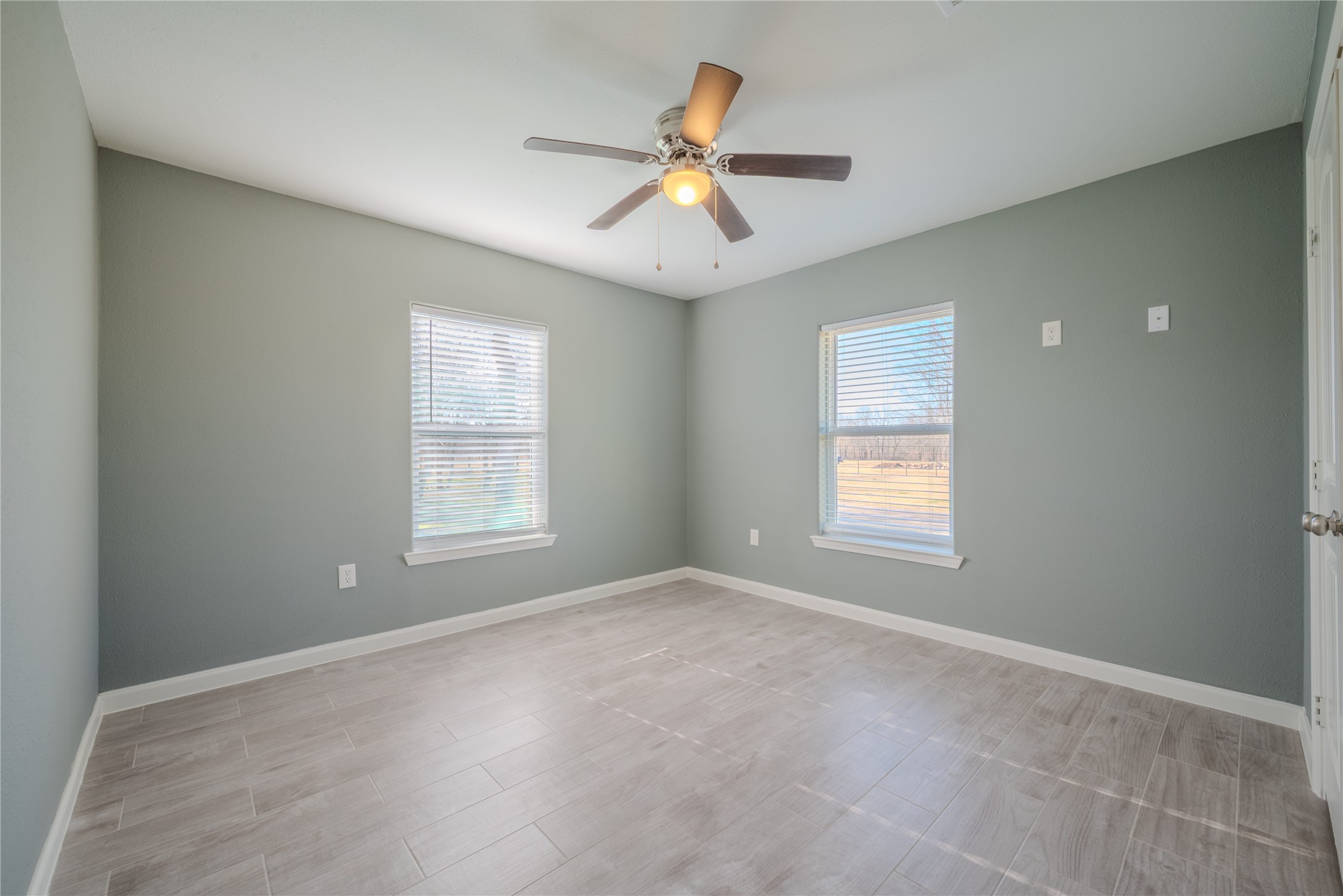 4340 Highway 60 Wharton, TX 77488 - Photo 17 of 49 Featuring tall windows and a refreshing palette, this bedroom offers a crisp, retreat-like atmosphere for residents or visitors.