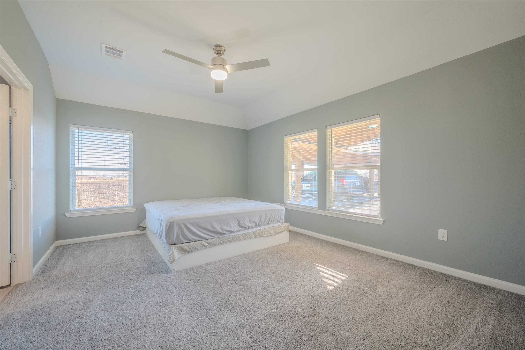 4340 Highway 60 Wharton, TX 77488 - Photo 25 of 49 The only carpeted room in the home, this large primary suite offers ultimate decompression with a modern ceiling fan and lovely window views.