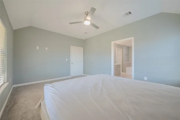 a large white bed in a white room