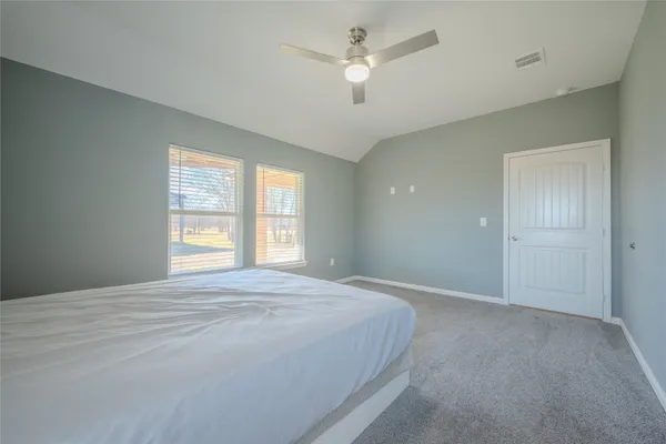 a spacious bedroom with a large bed and a window
