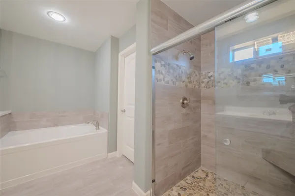a bathroom with a bathtub and a shower