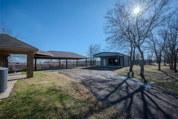 a brick house with tree in front of it