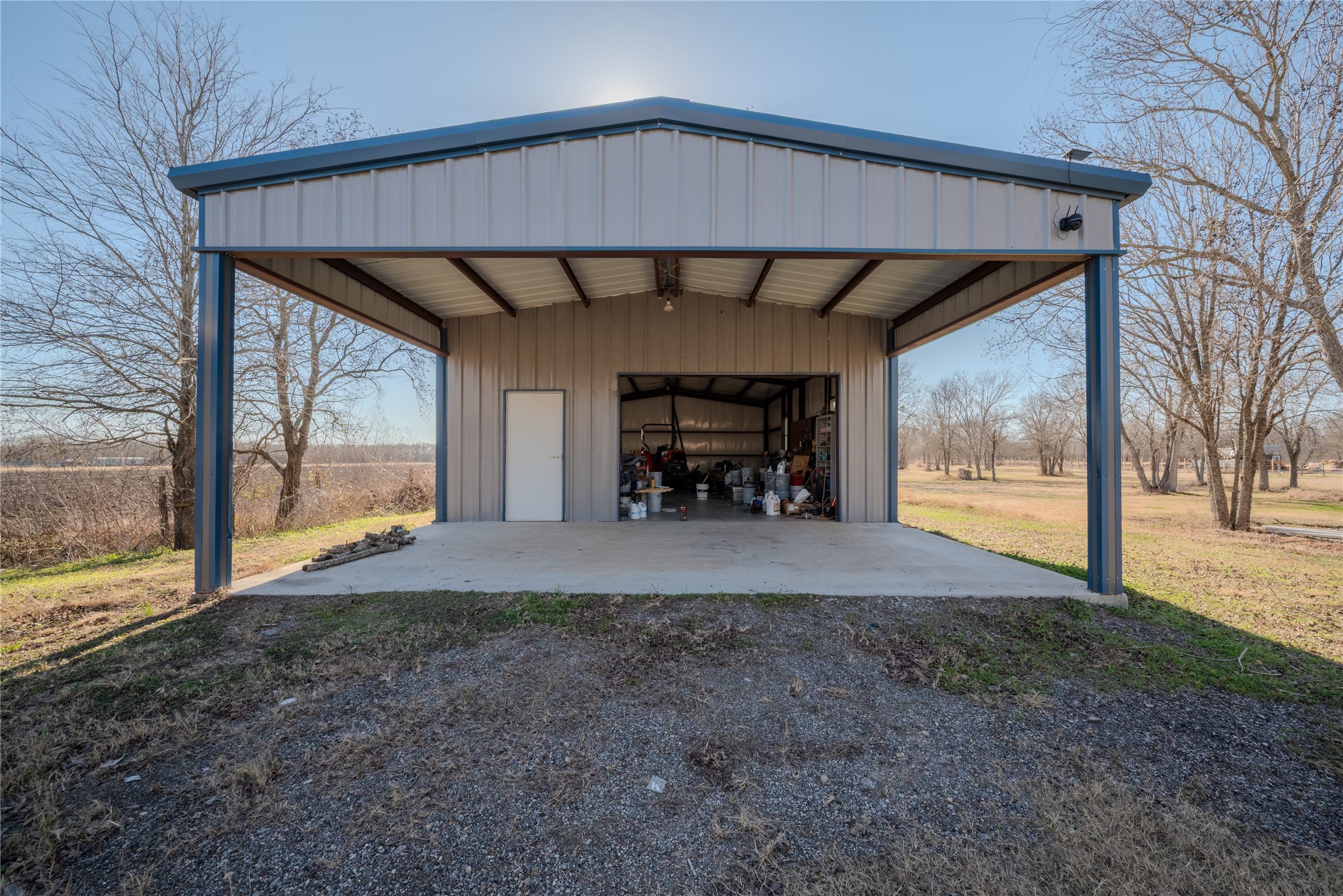 4340 Highway 60 Wharton, TX 77488 - Photo 39 of 49 A massive barn-garage combo featuring dual roll-up doors and an expansive attached carport for utility and various hobbies.