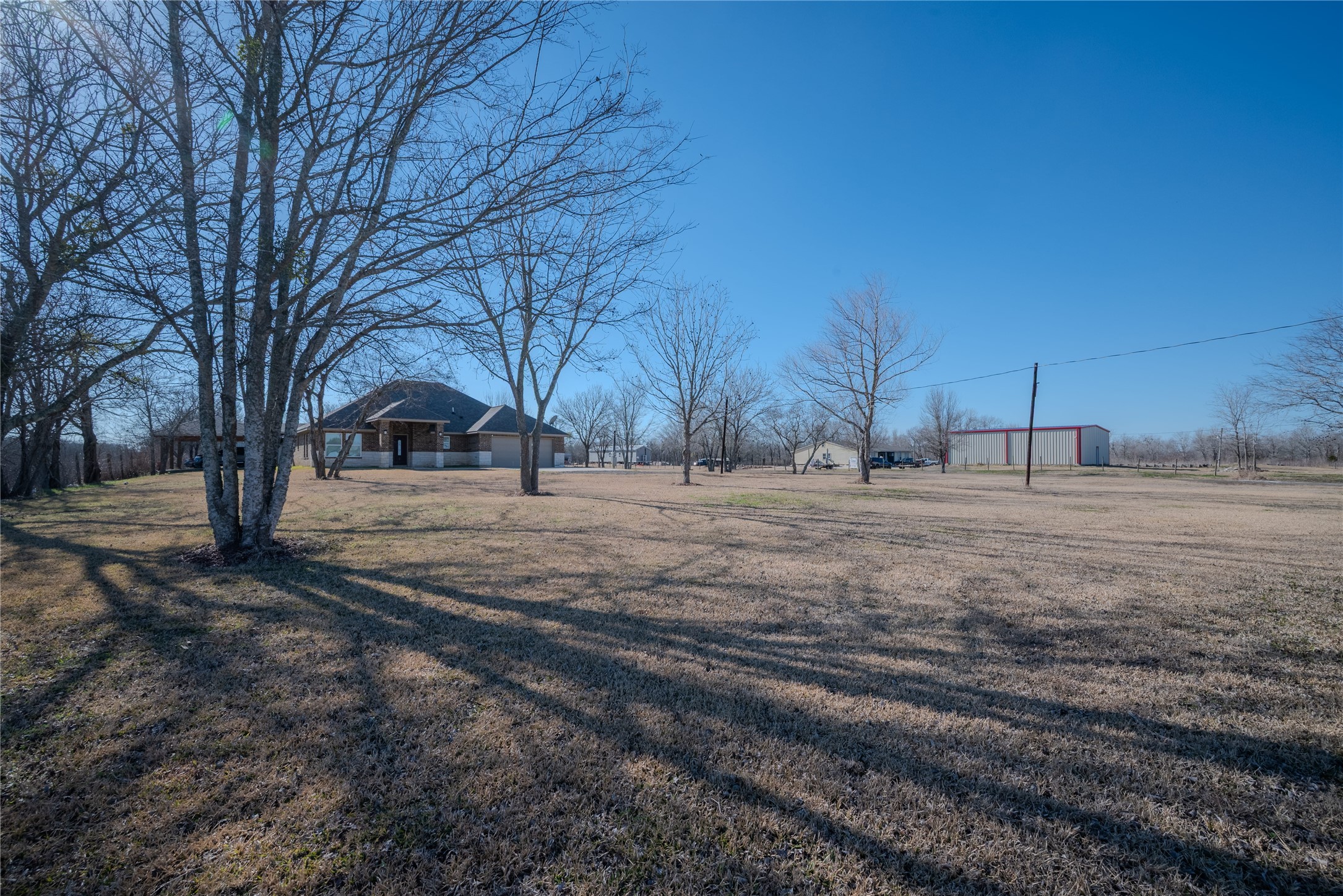 4340 Highway 60 Wharton, TX 77488 - Photo 42 of 49 The expansive grounds are beautifully dotted with mature trees, offering visual accents and pockets of shade across the property.