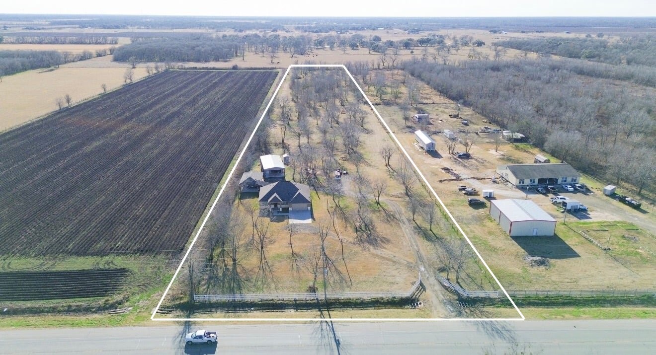 4340 Highway 60 Wharton, TX 77488 - Photo 49 of 49 This aerial perspective illustrates the impressive length of the property and the strategic placement of the home to maximize the space for future additions.