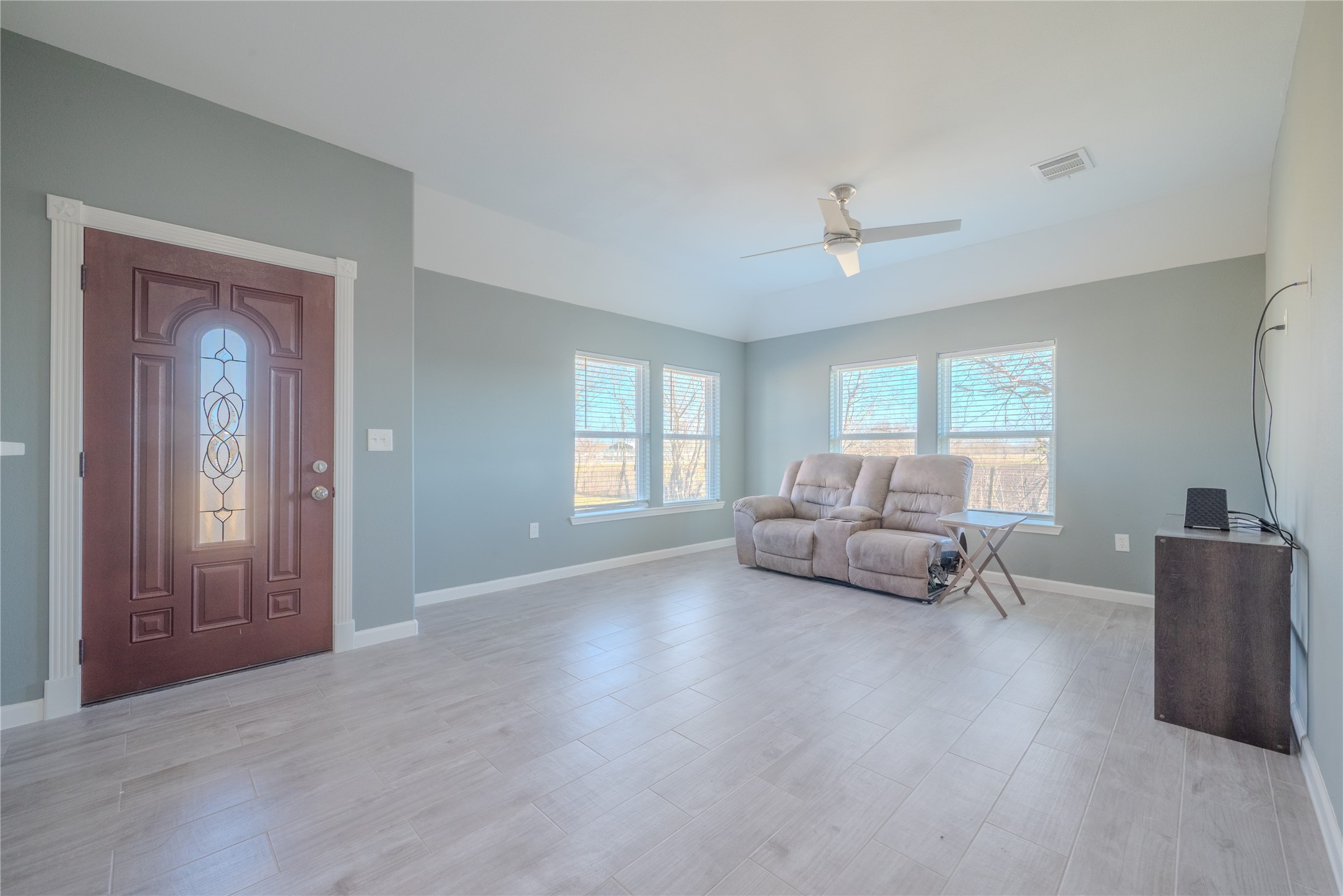 4340 Highway 60 Wharton, TX 77488 - Photo 7 of 49 The front door reveals a sprawling living zone where natural light dances across warm-toned tiles, creating a bright and airy social heart.