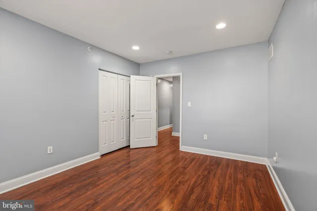 a view of an empty room with wooden floor