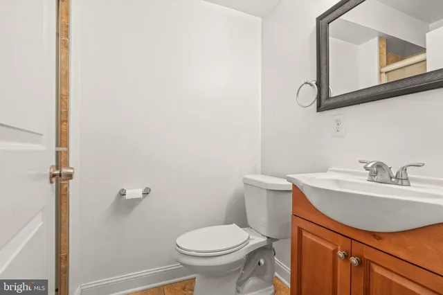 a bathroom with a sink toilet and mirror