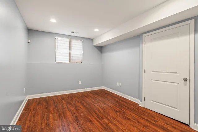 a living room with furniture and a glass door