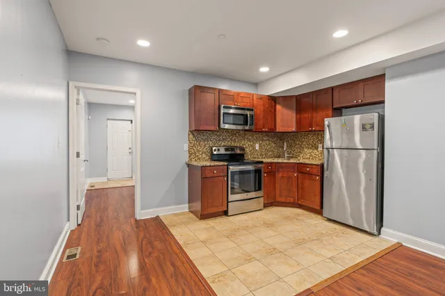 a kitchen with a refrigerator a stove top oven a sink and dishwasher
