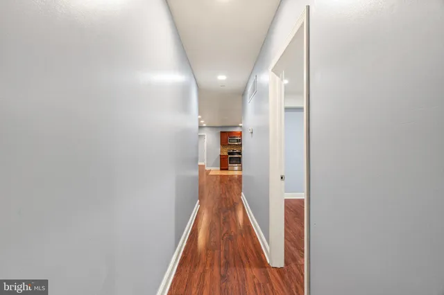 a view of a hallway with wooden floor