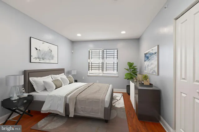 a bedroom with a bed and a potted plant