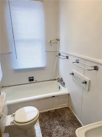 a bathroom with a sink a toilet and bathtub