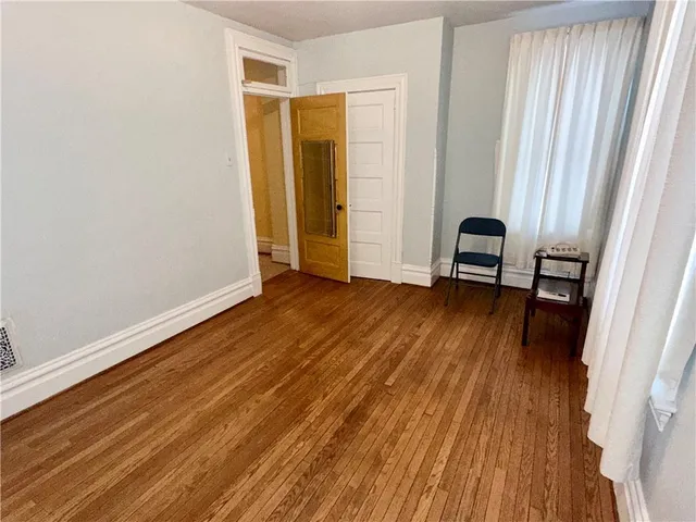 a view of a room with wooden floor and stairs
