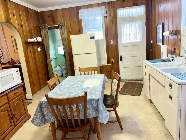 a view of a dining room with furniture and a chandelier