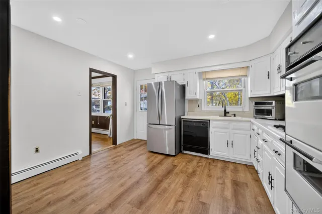 a kitchen with stainless steel appliances a refrigerator sink and stove