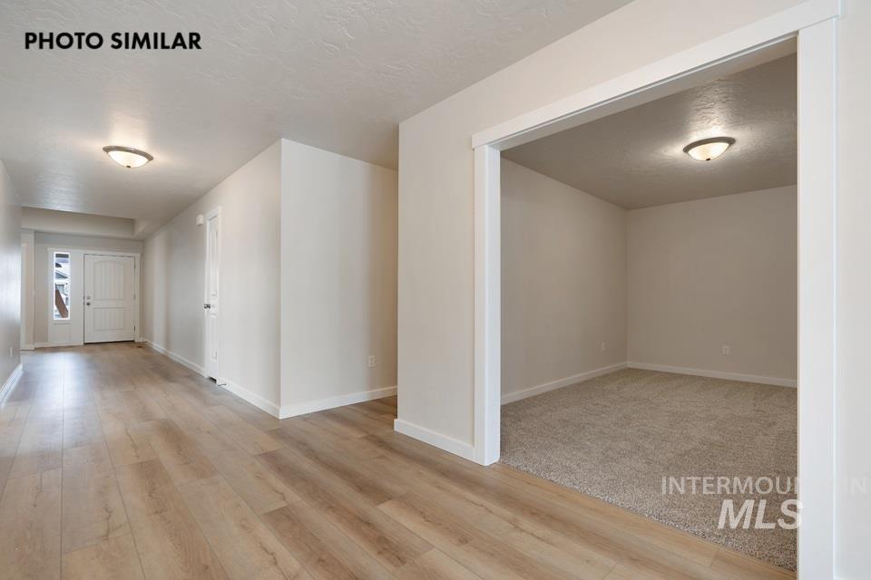 1645 Haystack Emmett, ID 83617 - Photo 4 of 33 Entryway featuring wood-finish flooring, white trim, and a flush-mount light fixture