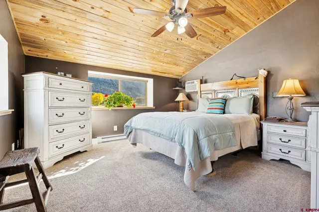 a bed room with a bed and a dresser
