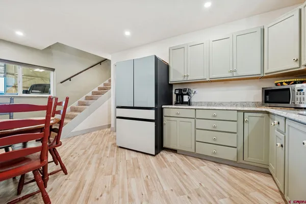 a kitchen with white cabinets and stainless steel appliances