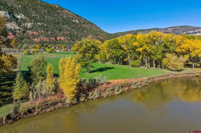 a view of a lake with houses in the back