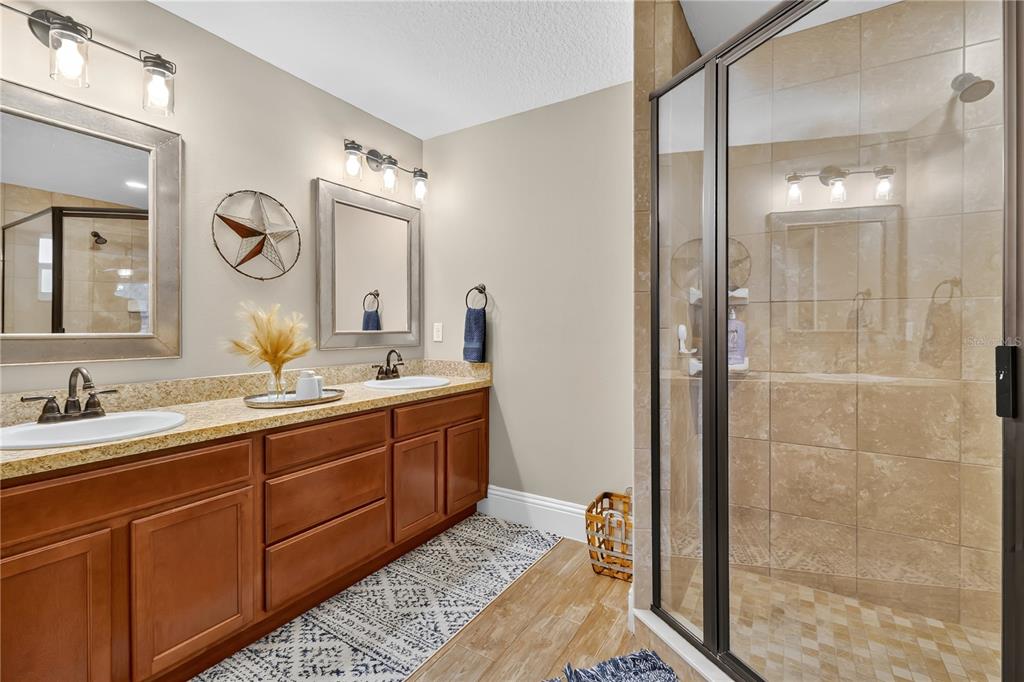 396 North Post Office Road Kenansville, FL 34739 - Photo 11 of 34 a spacious bathroom with a double vanity sink mirror and shower