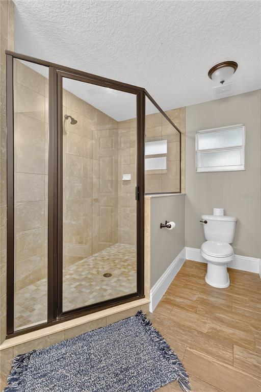 396 North Post Office Road Kenansville, FL 34739 - Photo 12 of 34 a bathroom with a toilet and a shower