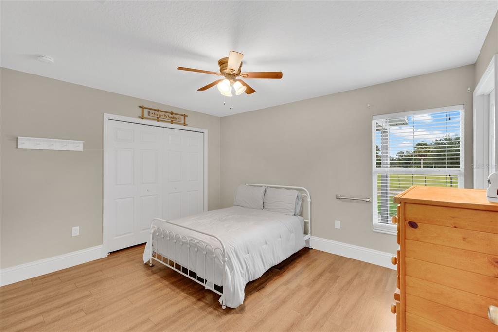 396 North Post Office Road Kenansville, FL 34739 - Photo 15 of 34 a bedroom with a bed and window