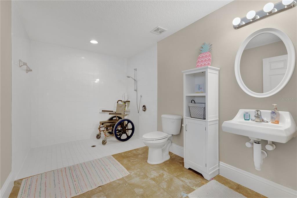 396 North Post Office Road Kenansville, FL 34739 - Photo 16 of 34 a bathroom with a sink toilet and shower