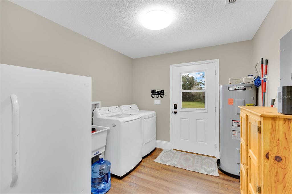 396 North Post Office Road Kenansville, FL 34739 - Photo 18 of 34 a utility room with dryer and washer
