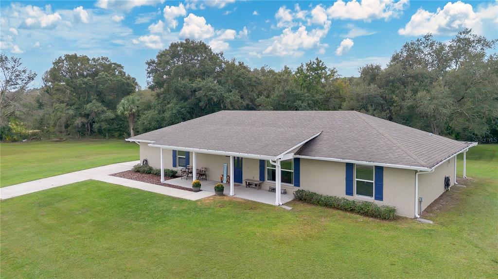 396 North Post Office Road Kenansville, FL 34739 - Photo 29 of 34 a aerial view of a house with a yard table and chairs