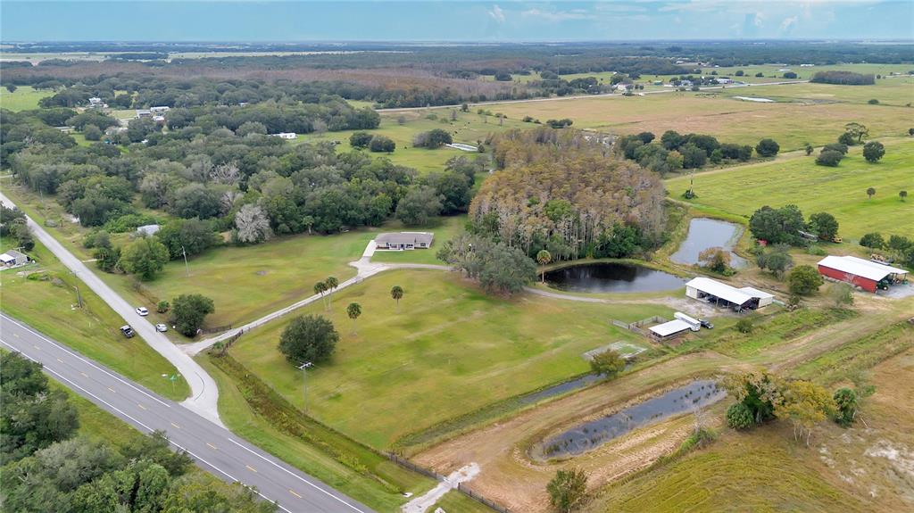396 North Post Office Road Kenansville, FL 34739 - Photo 30 of 34 a view of a swimming pool and an outdoor seating